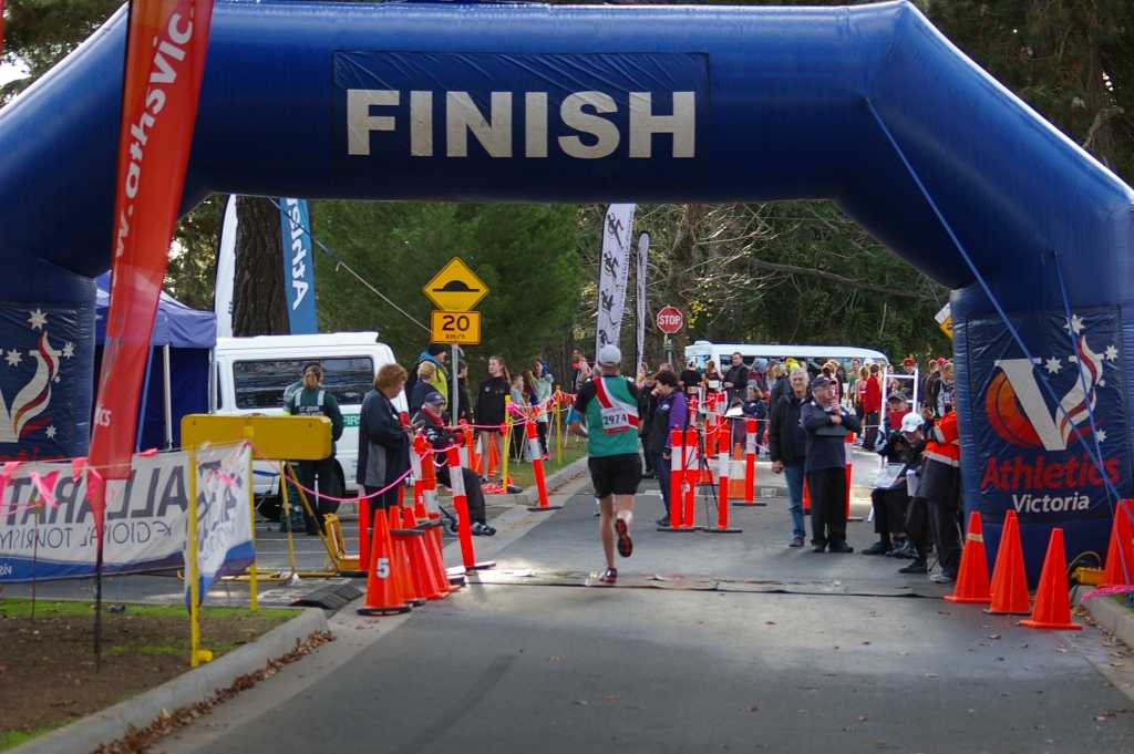 Travis crossing the finish line